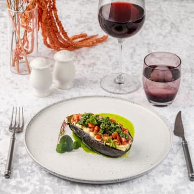 Запеченный баклажан с хумусом, томатами конкасе и соусом чимичури