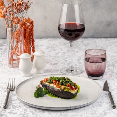 Запеченный баклажан с хумусом, томатами конкасе и соусом чимичури