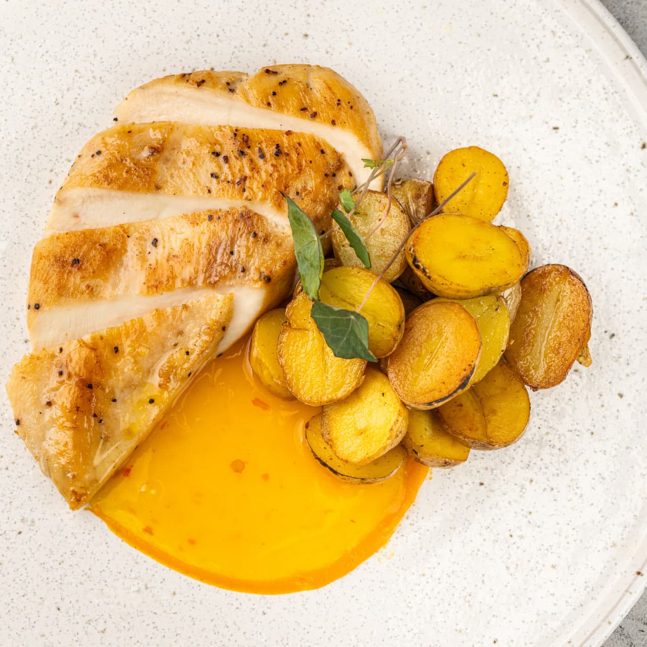 Стейк из куриной грудки с бейби картофелем в апельсиновом соусе